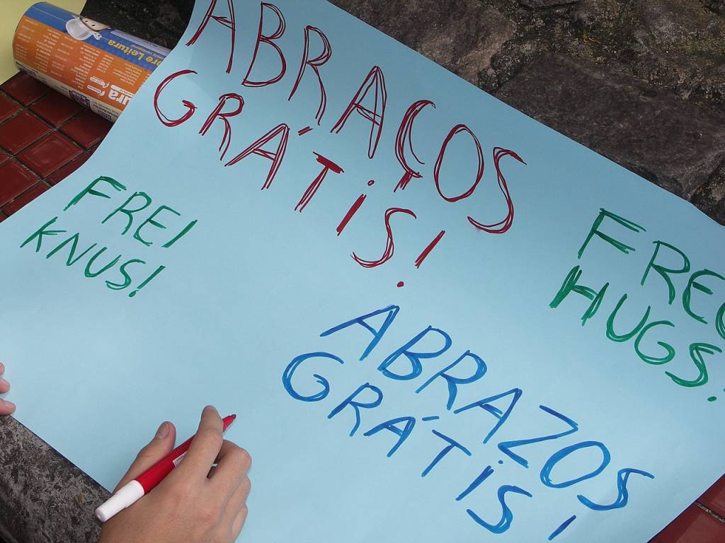 abraços-gratis Mão escreve em cartaz